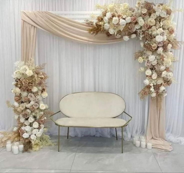 Elegant event backdrop with cream loveseat, white drapes, blush flowers—ideal for event management in Calicut.