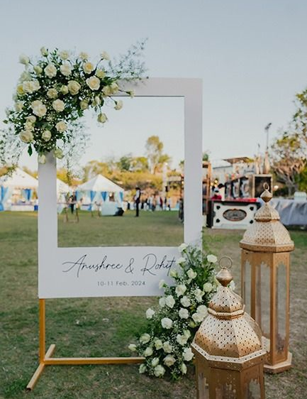 Elegant outdoor wedding setup with floral decorations and white drapes by an event management team in Calicut.